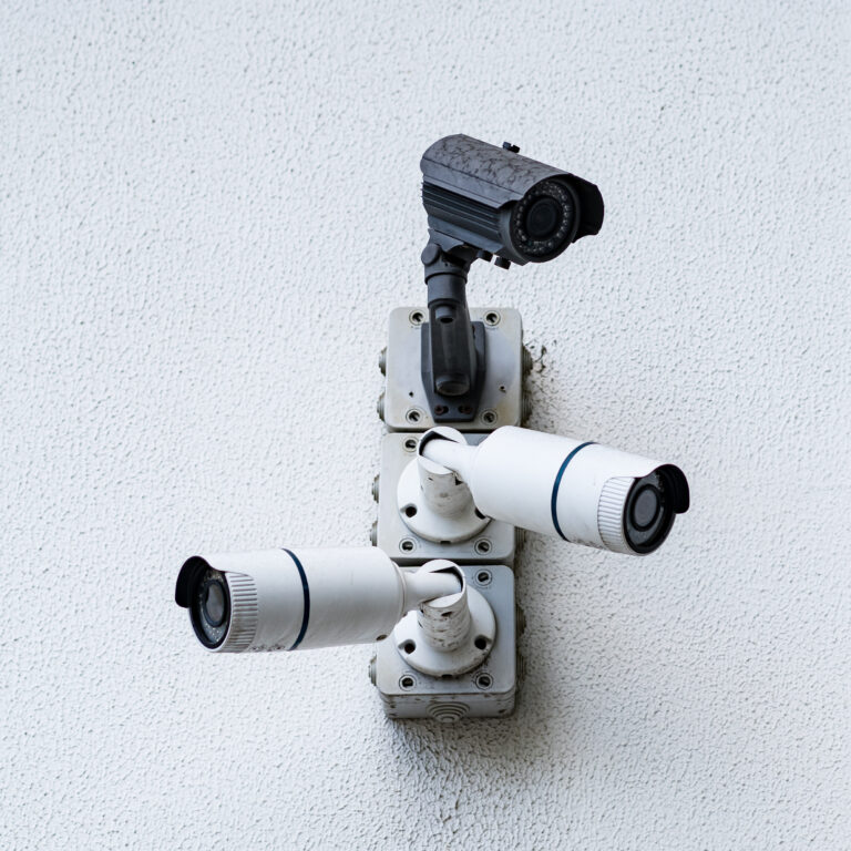 Security cameras on white modern building, technology concept